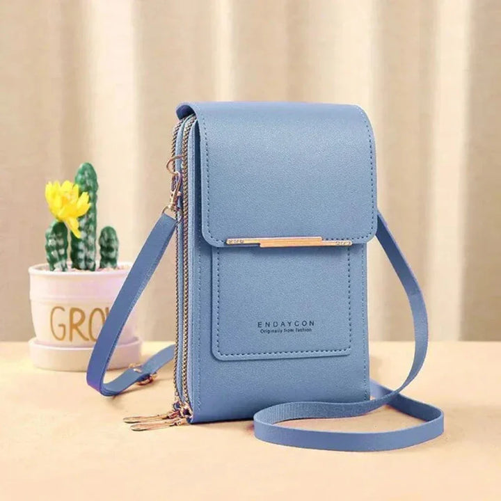 Compact women's touchscreen phone crossbody bag, featuring an organized interior for cards & small essentials.