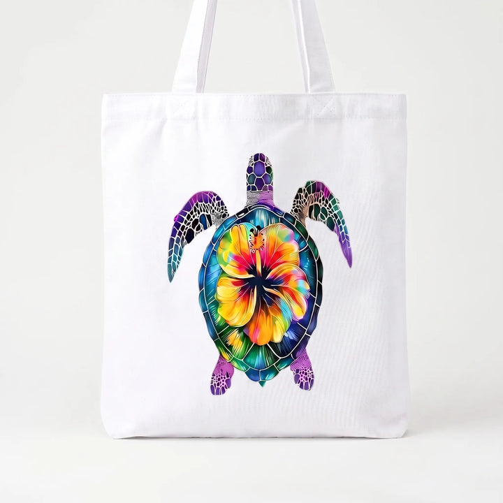 Turquoise women's shoulder tote with vibrant hibiscus floral print. A stylish and reusable everyday accessory.