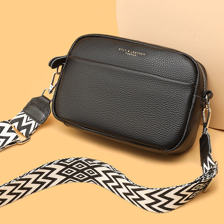 Interior view of an organized women's crossbody bag, showcasing practical compartments.