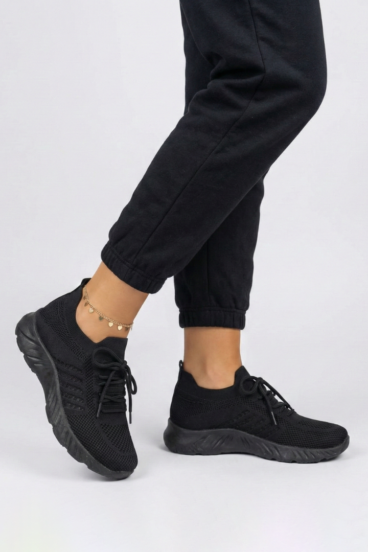 Fashionable women's white lace-up sneakers with sleek design, offering comfort & support for versatile everyday use.