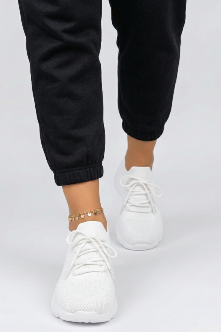 Bottom view of women's sneakers, revealing robust textured grip sole for enhanced stability in athletic & casual activities.
