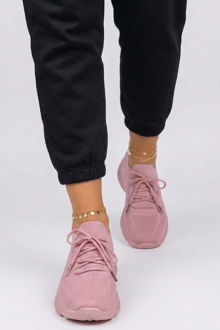 Dynamic shot of women's lace-up sneakers in action, showcasing textured grip and flexible design for active lifestyles.
