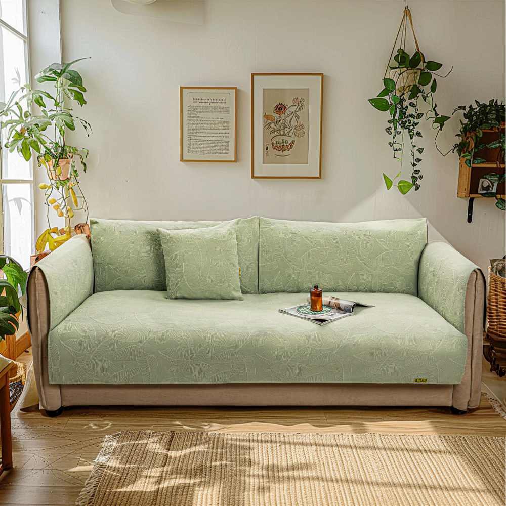 Stretch jacquard couch protector in a modern living room, fitting a three-seater sofa.