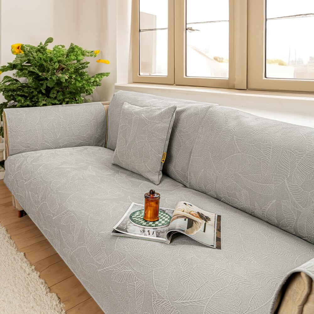 Pet-friendly jacquard slipcover for a large couch, offering durable furniture protection.