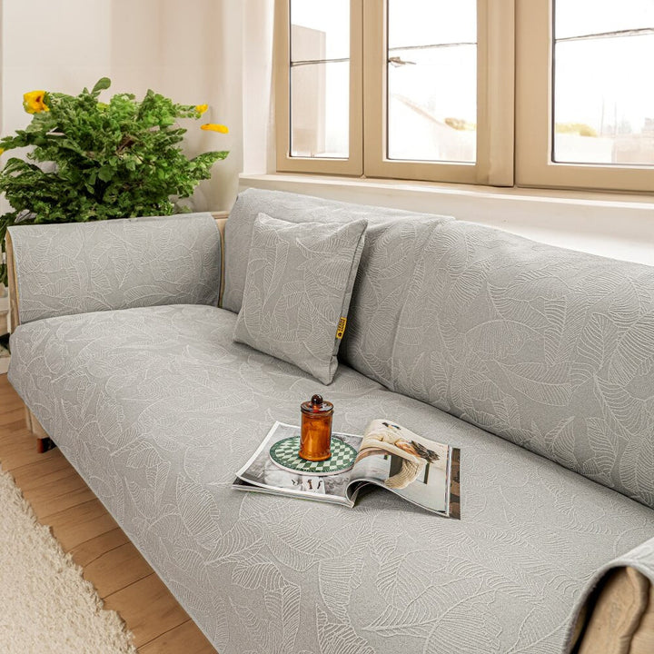 Pet-friendly jacquard slipcover for a large couch, offering durable furniture protection.