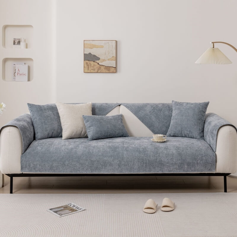 Packaging of a new Textured Waffle Chenille Sofa Cover, emphasizing its pet-friendly features.
