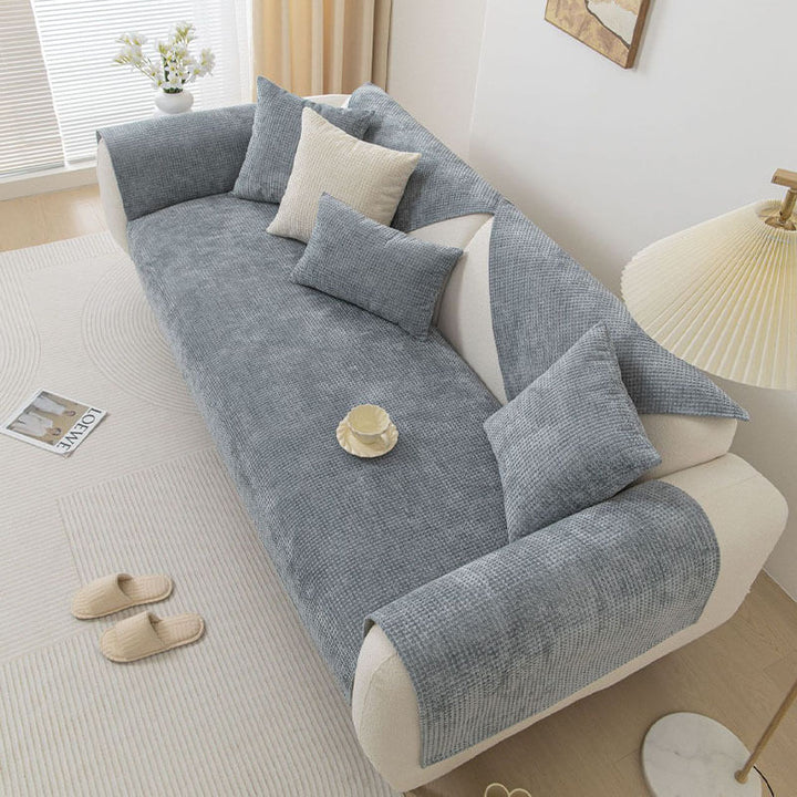 Arrangement of throw pillows on a Textured Waffle Chenille Furniture Protector couch cover.