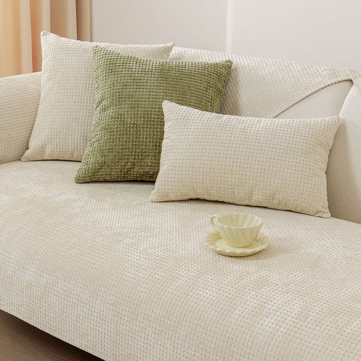 Corner of a sectional sofa with a perfectly fitted Textured Waffle Chenille pet-friendly cover.