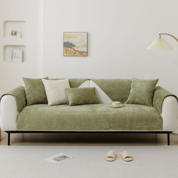 Sectional couch featuring a pet-friendly Textured Waffle Chenille Furniture Protector in black.
