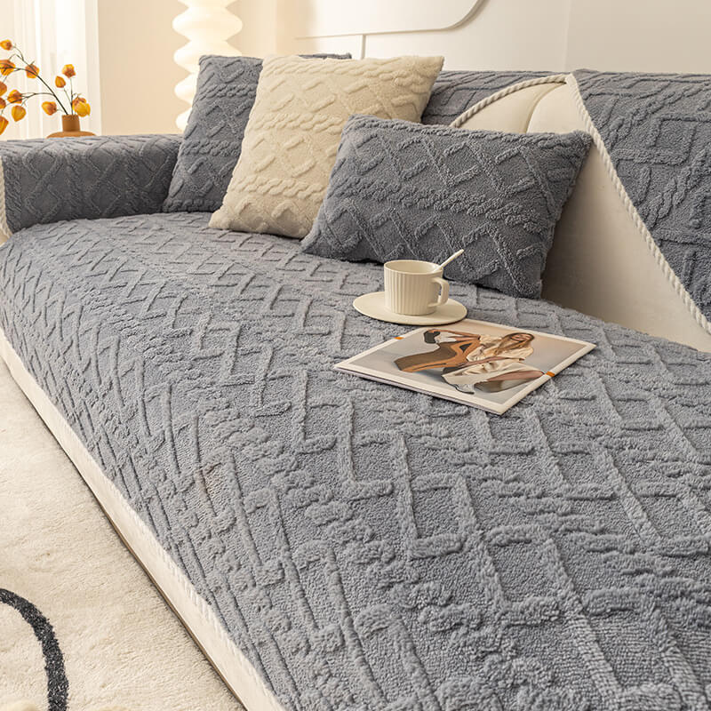 Thickened plush non-slip sofa cover in a neutral color, perfect for pet owners, protecting furniture.