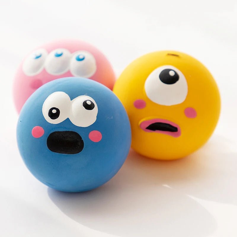 Three durable squeaky dog chew balls, vibrant and textured for aggressive chewers.
