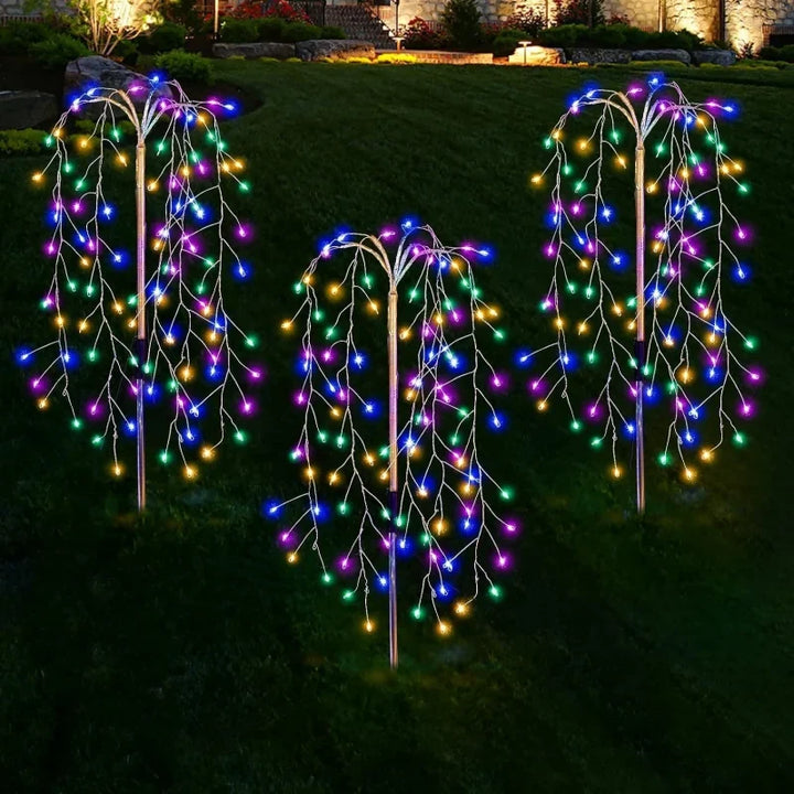 Three solar garden lights illuminating a pathway, perfect for outdoor decor and accent lighting.