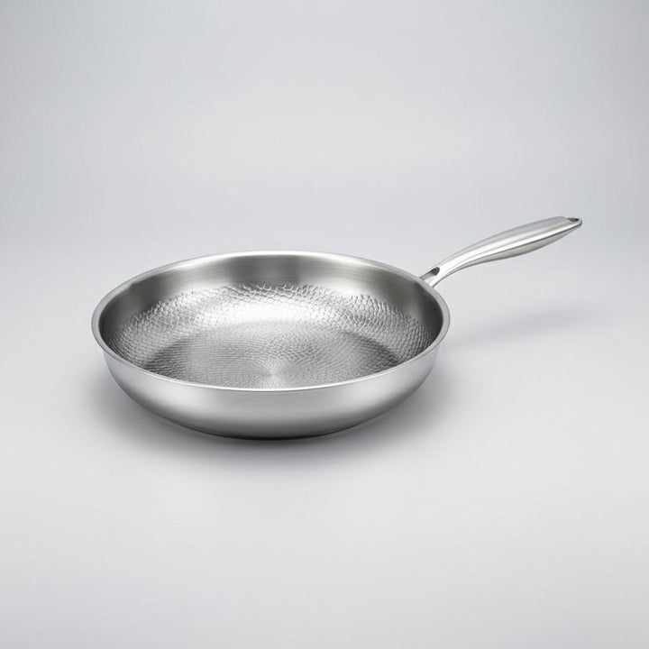 Modern kitchen non-stick titanium hammered skillet. Induction ready frying pan for delicious meals, durable.
