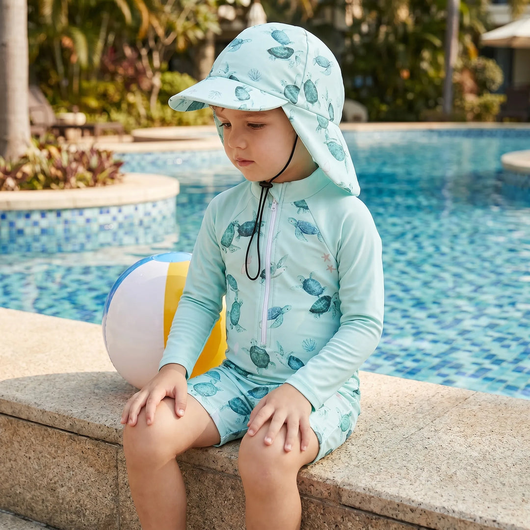 Toddler long-sleeve rash guard swimsuit set with sun protection hat. Perfect for beach & pool play.
