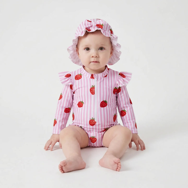 Vibrant printed long-sleeve toddler swimsuit with ruffles & sun hat. UPF 50+ rashguard for beach or pool.
