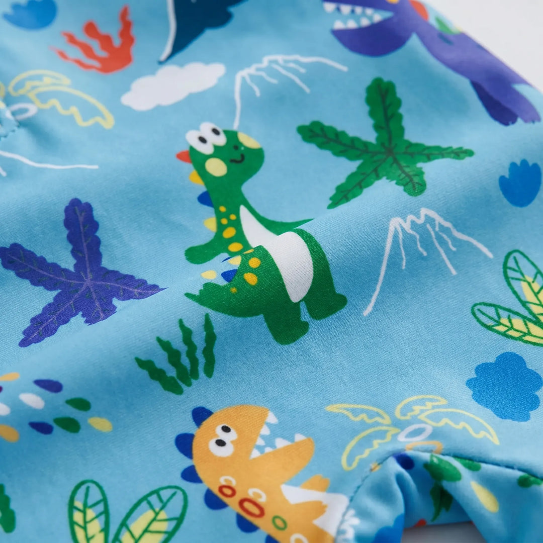 Smiling toddler in a vibrant long sleeve swim set with a flap hat, enjoying splash time at the pool.