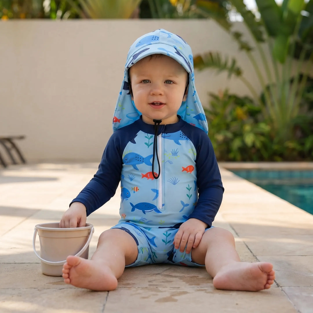 Long-sleeve toddler swim romper & hat set. Ocean print, quick-dry, UPF 50+ sun protection for kids.