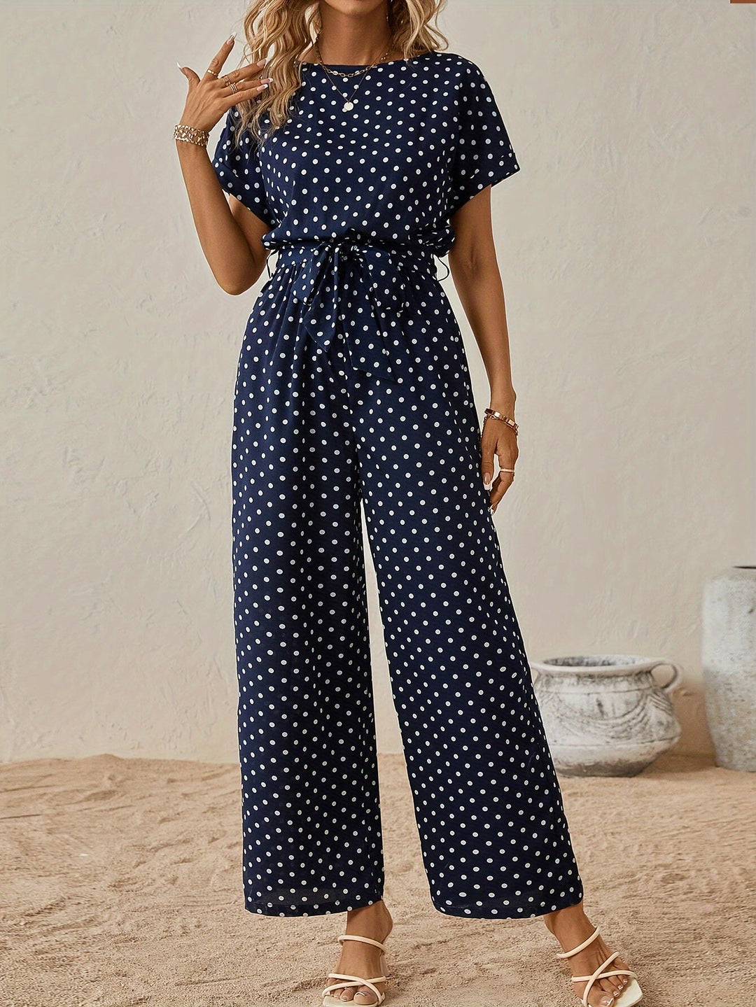 Trendy women's polka dot jumpsuit with elastic waist & short sleeves, ideal for summer casual wear.