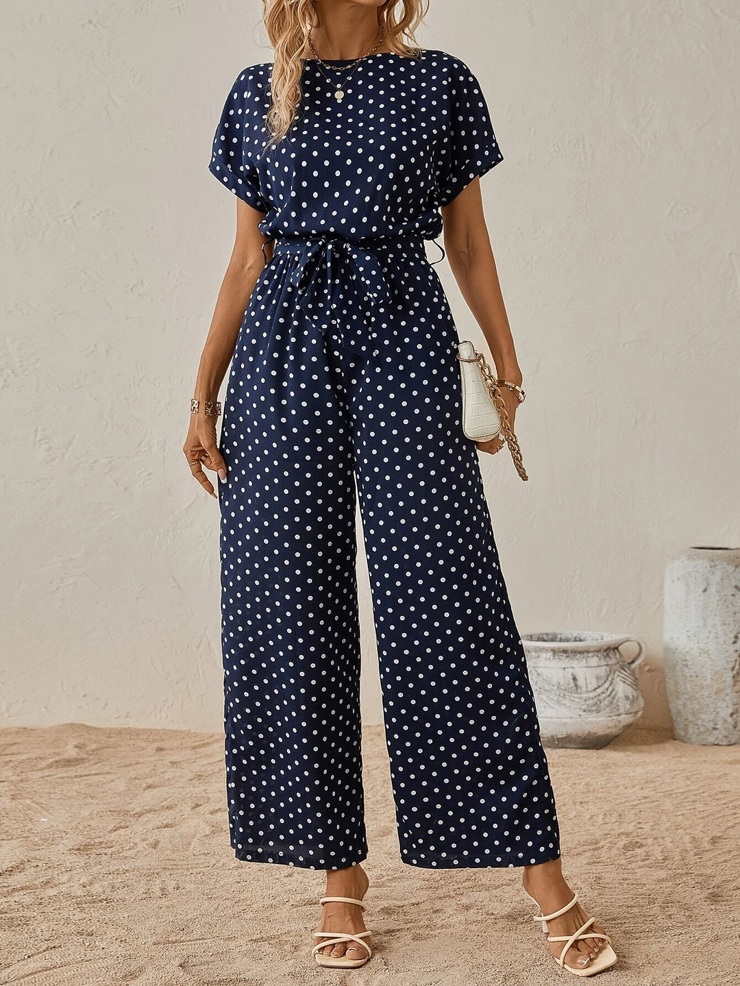 Stylish polka dot women's jumpsuit, perfect for summer casual wear. Features elastic waist & short sleeves.