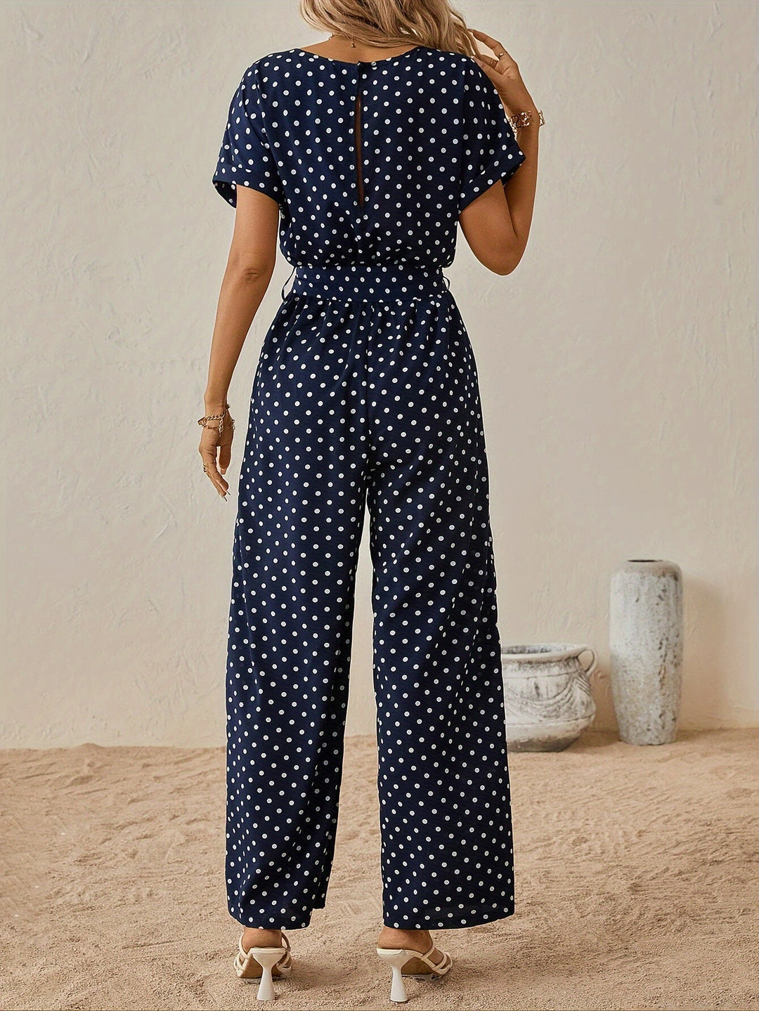 Casual women's polka dot short-sleeve jumpsuit with elastic waist, versatile for spring & summer style.