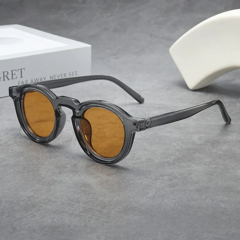 Classic round unisex sunglasses featuring smoke amber tinted lenses & a stylish tortoise frame. Durable fashion eyewear.