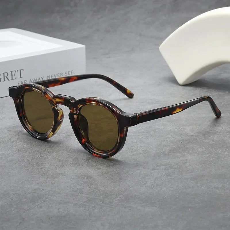 Unisex round sunglasses with smoke amber tinted lenses. Classic style eyewear with a tortoise frame.