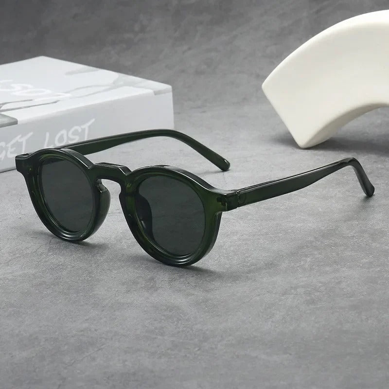 Fashionable unisex classic round sunglasses. Tinted smoke amber lenses complement the durable tortoise frame eyewear.