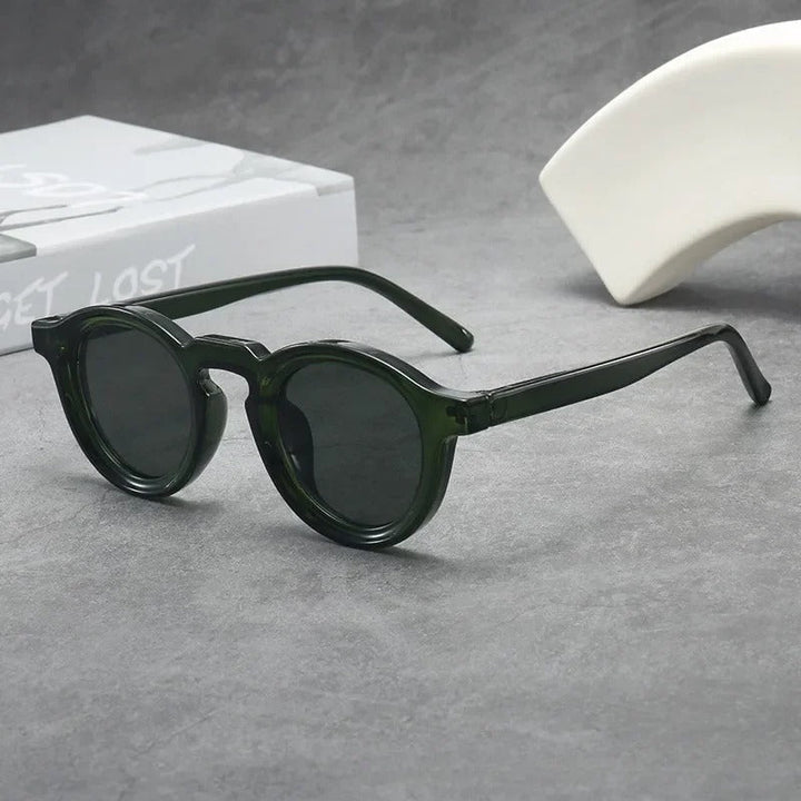 Fashionable unisex classic round sunglasses. Tinted smoke amber lenses complement the durable tortoise frame eyewear.