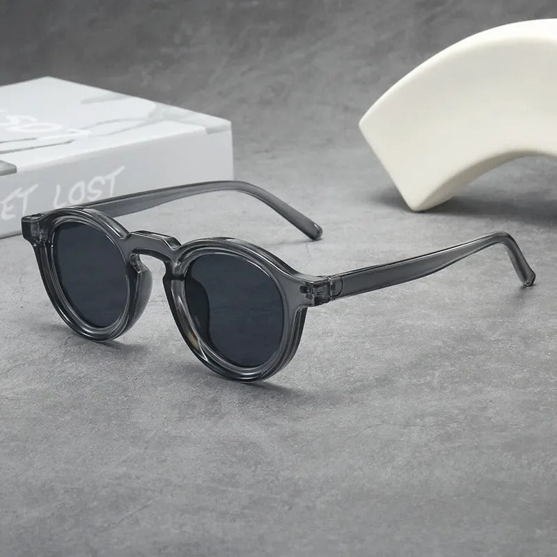 Durable classic round unisex sunglasses with smoke amber tinted lenses. Lightweight tortoise frame fashion accessory.