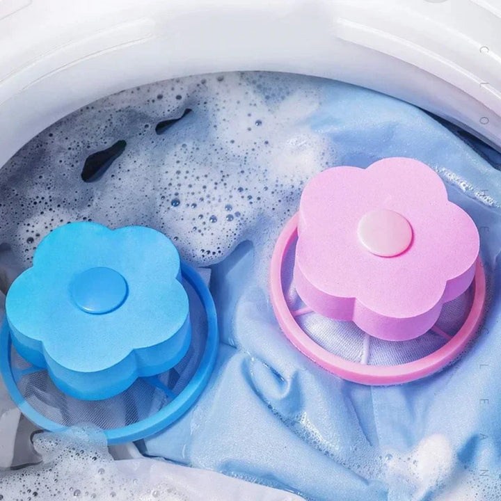 Close-up of a pink floating lint catcher in a washing machine tub, removing pet hair