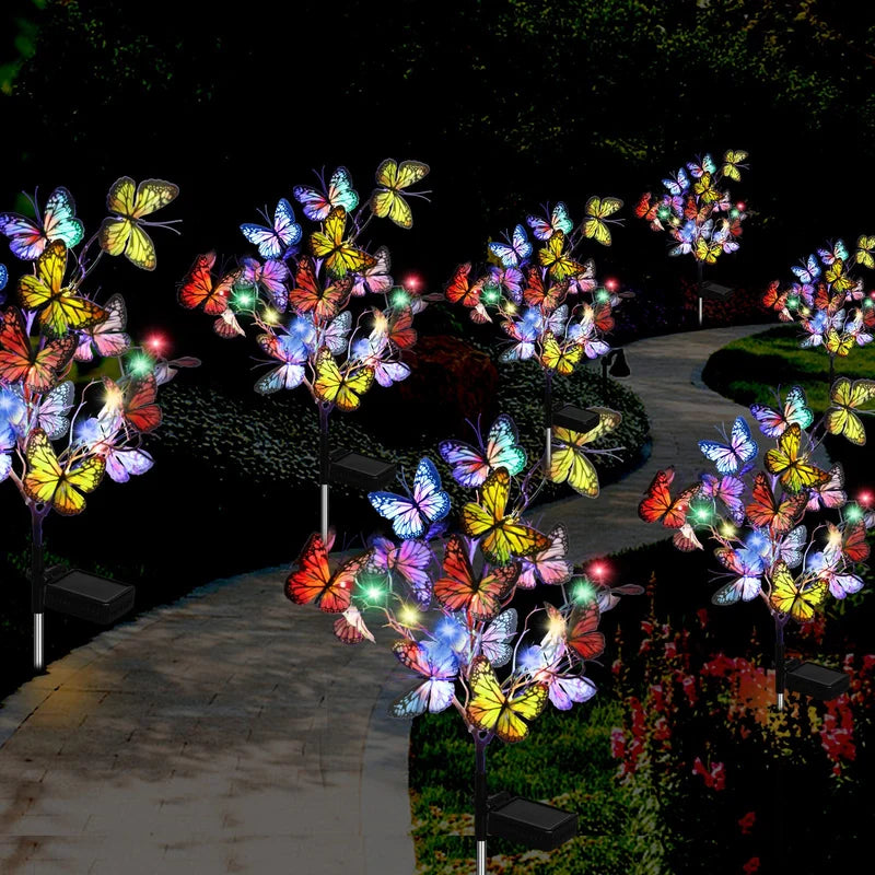 Vibrant butterfly-shaped solar garden lights, adding a decorative touch to a green lawn patio setup.