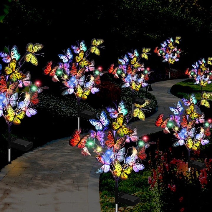 Vibrant butterfly-shaped solar garden lights, adding a decorative touch to a green lawn patio setup.