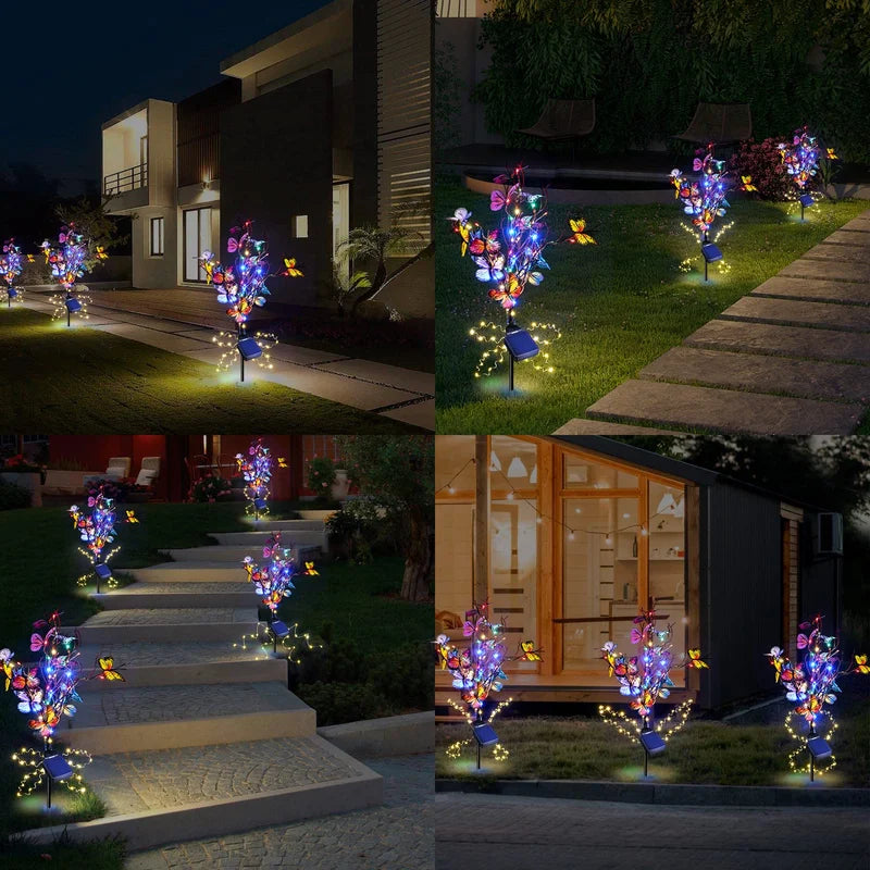 Two decorative solar butterfly lights installed in a garden bed, a great gift idea for outdoor enthusiasts.