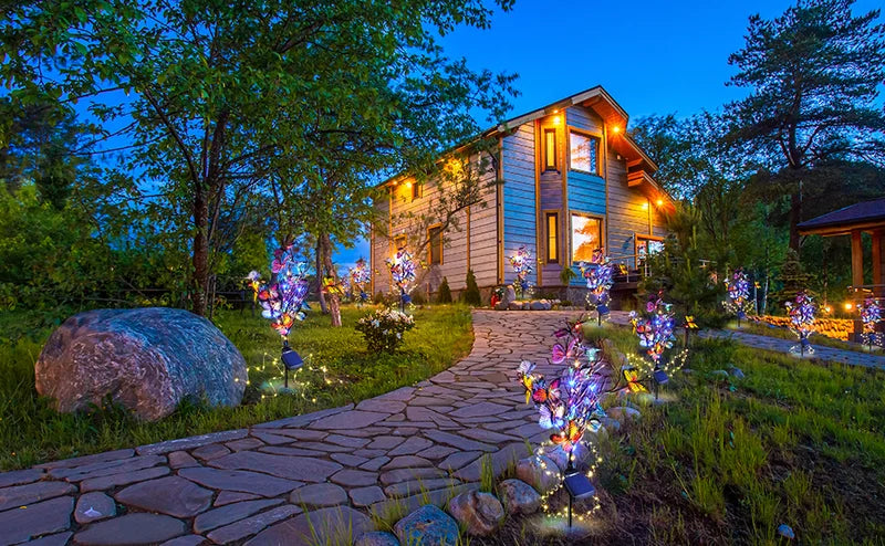 Butterfly garden lights powered by solar energy, casting beautiful patterns on a garden path.
