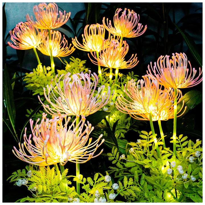 Two solar powered glowing flower stake lights illuminating a garden path at dusk, energy efficient