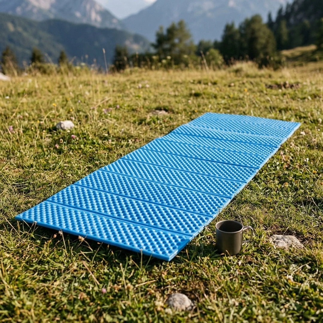 Ultralight blue foldable camping mat for hiking. Portable closed-cell sleeping pad for outdoor adventures.