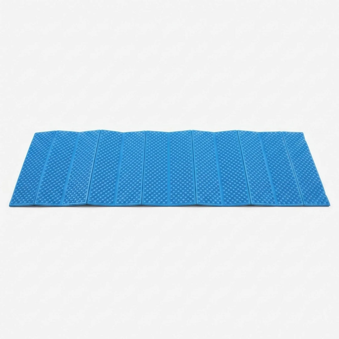 Compact, folded blue ultralight camping mat. Portable closed-cell foam sleeping pad for easy transport on hikes.