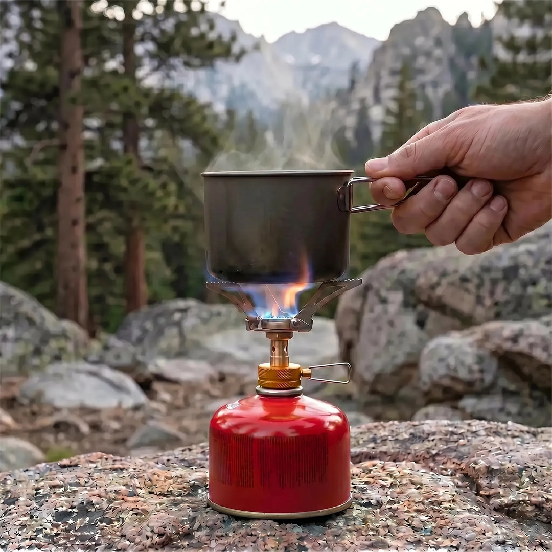 Close-up of ultralight gas burner stove, powerful flame ready for efficient camping outdoor cooking.
