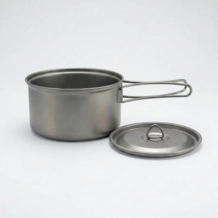 Titanium ultralight camp cookware set with folding handles, ideal for compact backpacking and outdoor cooking.