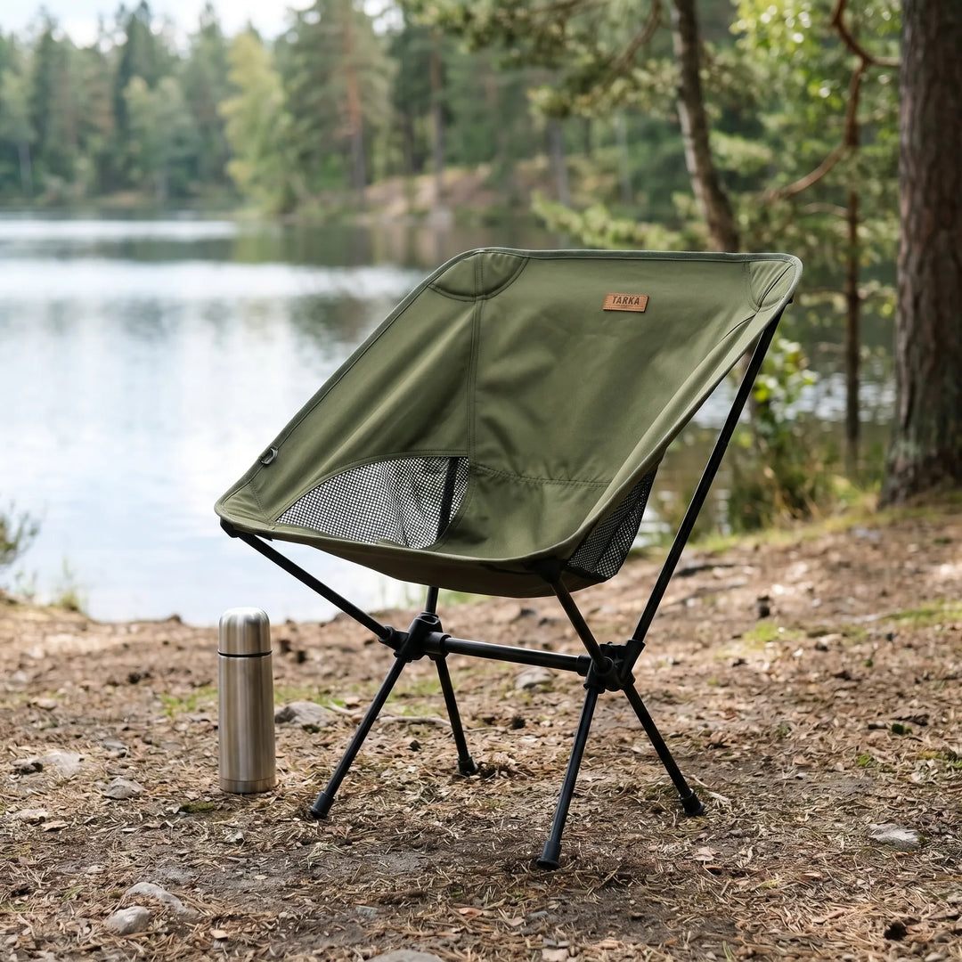 Ultralight folding camping chair for outdoor adventures. Portable, compact design with aluminum frame and mesh back.