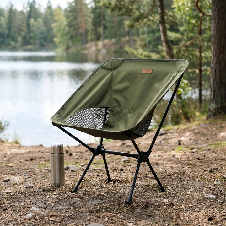 Ultralight folding camping chair for outdoor adventures. Portable, compact design with aluminum frame and mesh back.