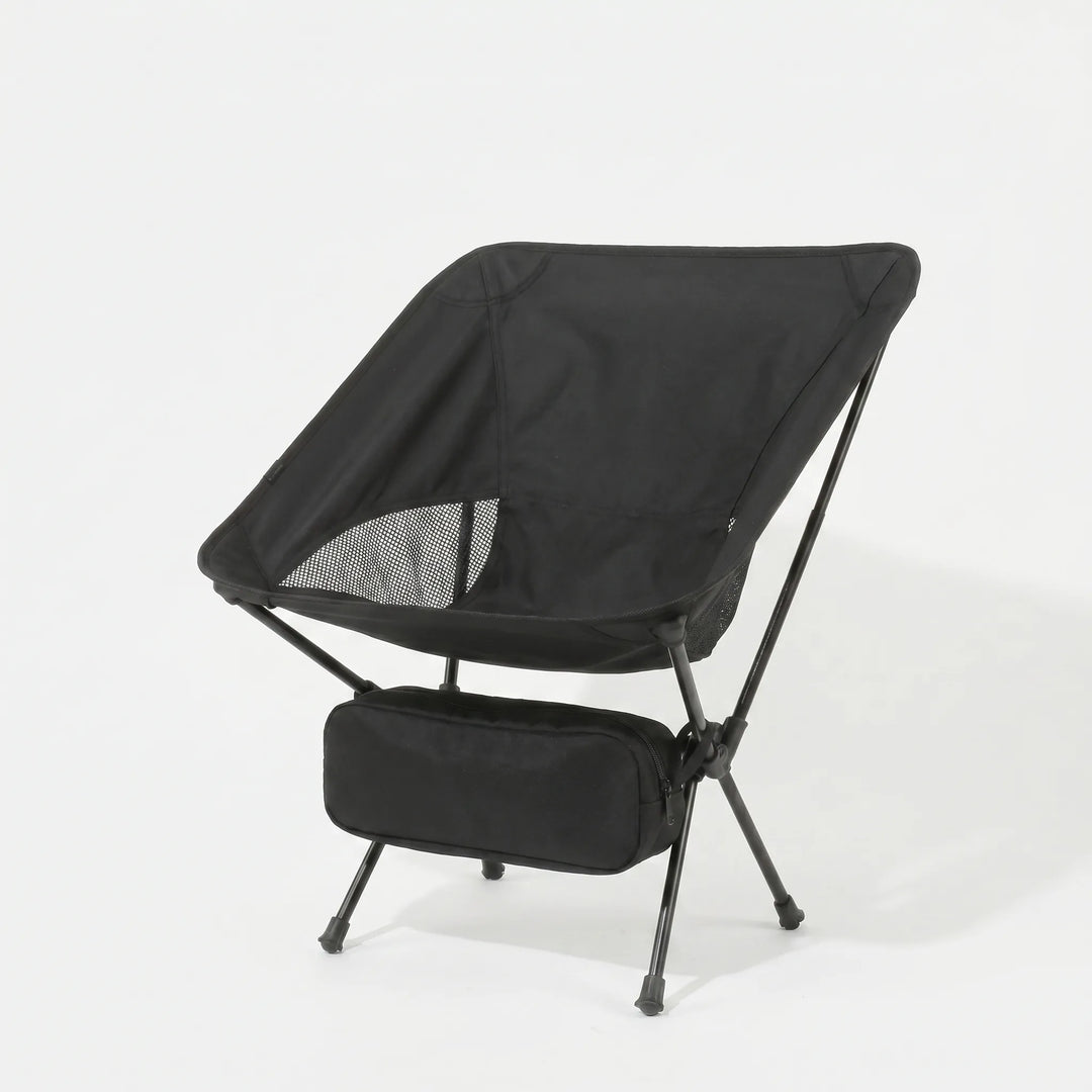 Lightweight folding camping chair in a natural setting, perfect for outdoor adventures, hiking, and comfortable seating.