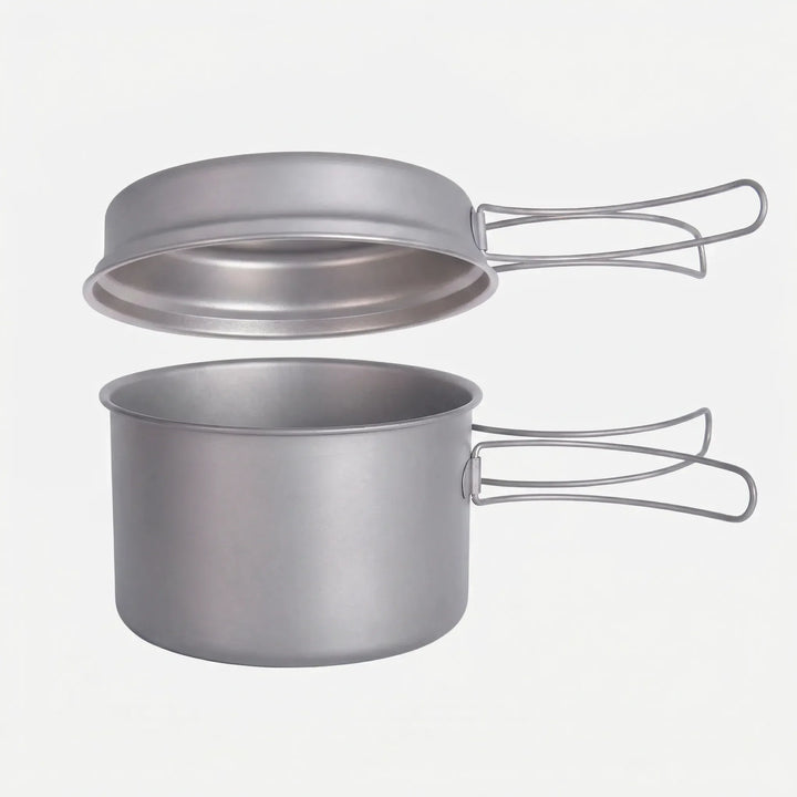 Compact nesting titanium cookware set with folding handles for ultralight backpacking. Essential hiking gear.