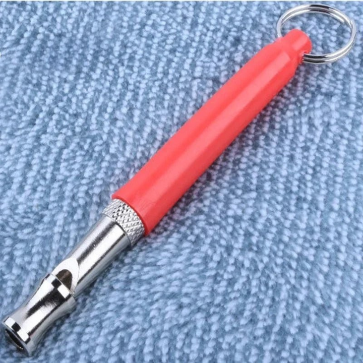 Close-up of a sleek ultrasonic dog whistle, ideal for obedience and recall training