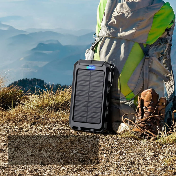 Rugged 20000mAh solar power bank, waterproof portable charger with LED flashlight for outdoor adventures.