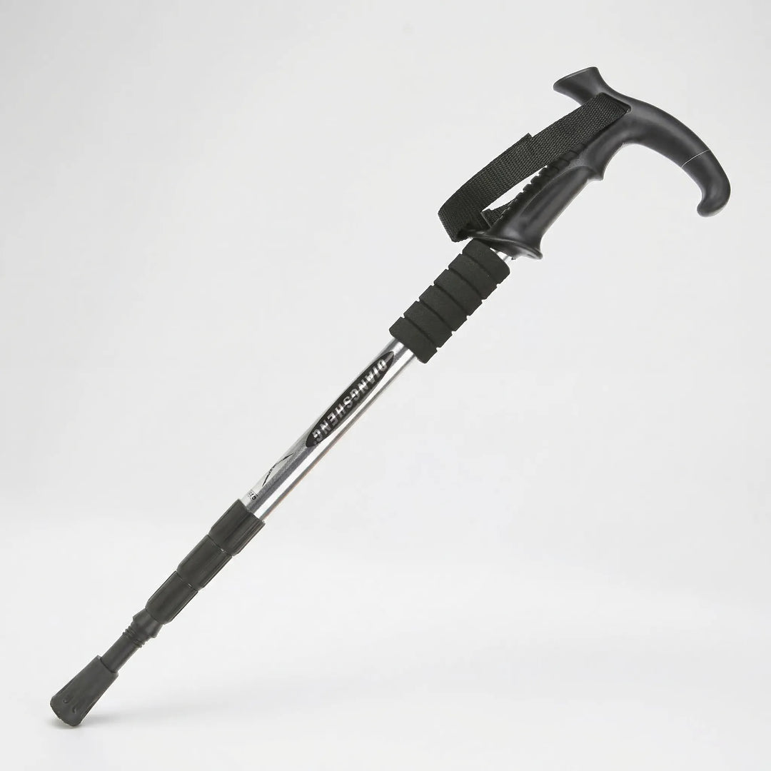 Ergonomic grip on a 4-section adjustable trekking pole. Essential compact hiking & walking outdoor gear.