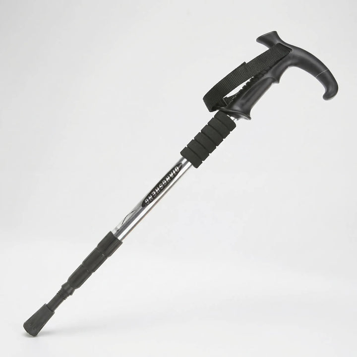 Ergonomic grip on a 4-section adjustable trekking pole. Essential compact hiking & walking outdoor gear.