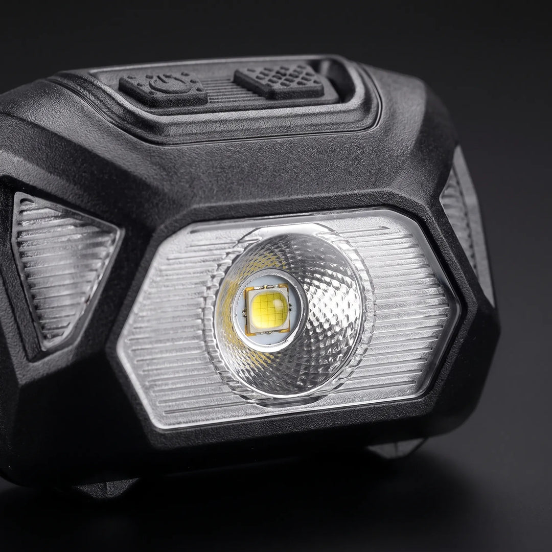 Compact LED headlamp, essential gear for night hiking, camping, and outdoor exploration; hands-free illumination.