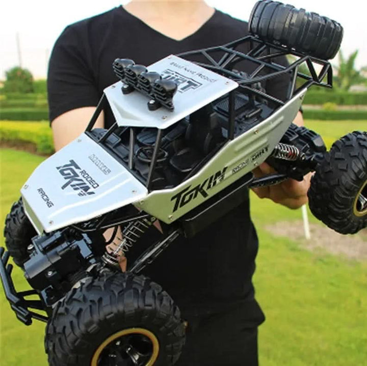 Child excitedly controlling a durable Remote Control Monster Truck in a sunny park setting.