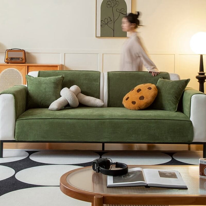 Unisex anti-slip corduroy sofa cover in a neutral color, protecting furniture in a pet-friendly home.